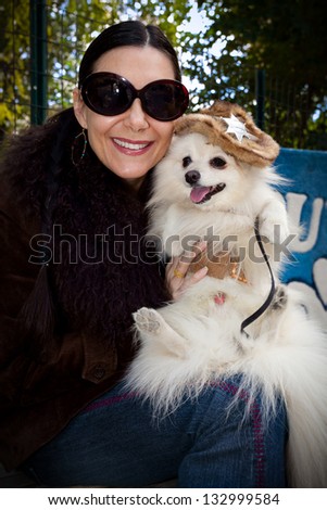 NEW YORK - OCTOBER 24, 2010: An unidentified woman shows off her dog who is dressed as a cowboy as part of the annual Tompkins Square Halloween Dog Parade. The event included a costume contest.