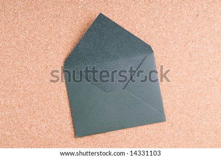 open Green Envelope on cork background