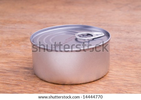 Closed Food Can on a Wooden Table
