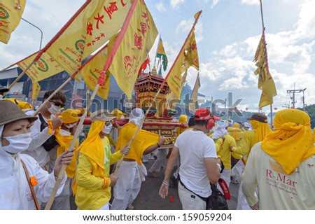 PHUKET - OCTOBER 13: an unidentified people who have faith of a Chinese Taoist shrine carry a palanquin housing a Chinese God idol in a street October 13, 2013 in Phuket Province, Thailand.