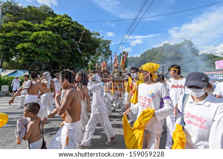 PHUKET - OCTOBER 13: an unidentified people who have faith of a Chinese Taoist shrine carry a palanquin housing a Chinese God idol in a street October 13, 2013 in Phuket Province, Thailand.