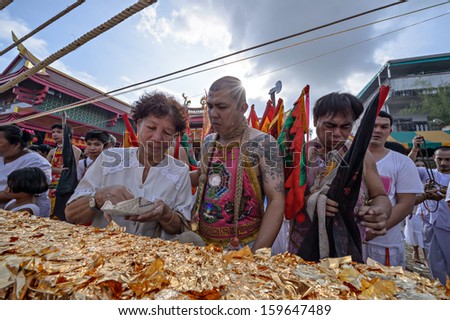 PHUKET - OCTOBER 14: an unidentified woman a Perform a ceremony Set The sacred wood poles is the symbol of the beginning Phuket Vegetarian Festival October 14, 2012 in Phuket Province, Thailand.