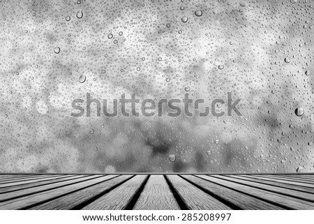 old wooden floor platform with rainy drops water on glass background
