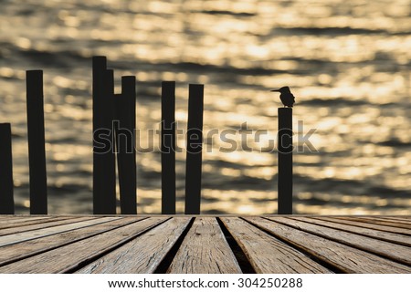 old wooden floor platform and silhouette bird background