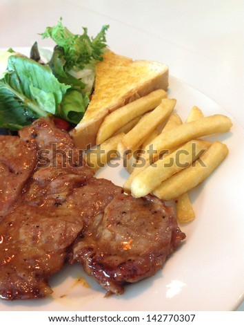 Steak,French fries and vegetables