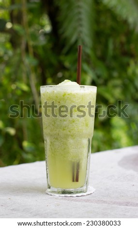 Smoothie of green apple on table.
