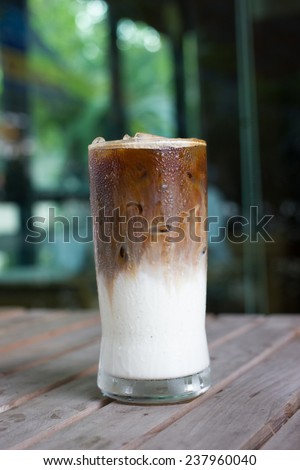 cold late coffee drink with ice on table.