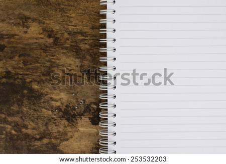 Open blank notebook on wood background