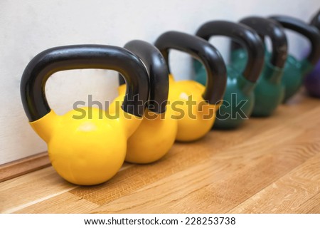 Colorful kettle bells on the floor in the gym