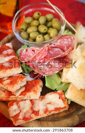 Delicious food platter with salami, bread, pizza and olives