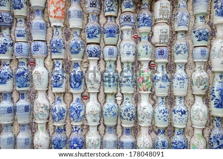 a house wall full with vases made of china, or blue and white porcelain