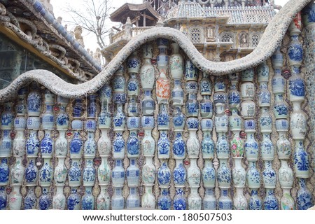 a building wall full with vases made of blue and white porcelain