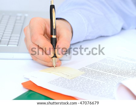 Boss is making correction notes in a contract