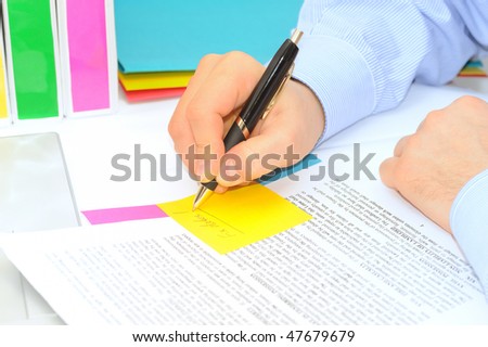 Boss is making correction notes in a contract