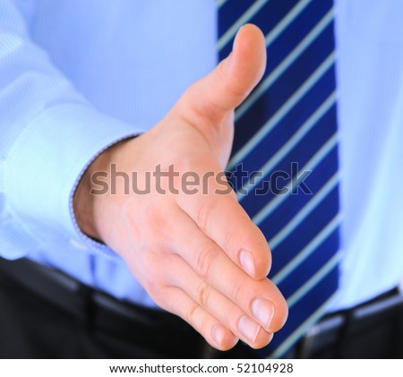 Well-dressed businessman is giving a handshake