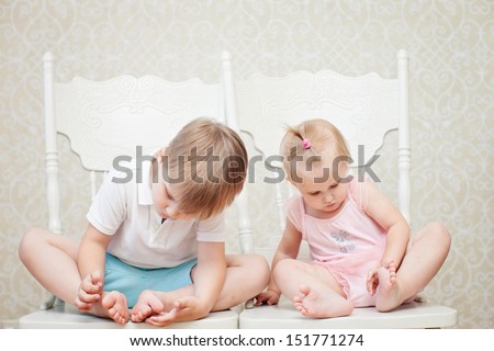 brother and sister looking at their feet