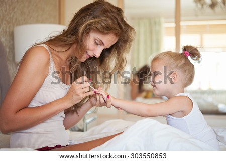 mother daughter in the morning bed