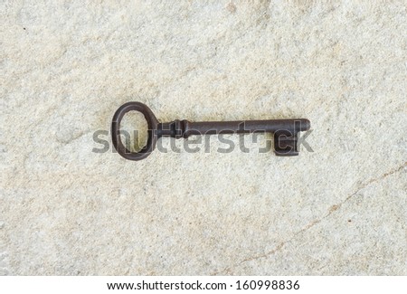 old key lying on a gray stone