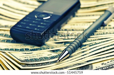 phone and pen on the money background