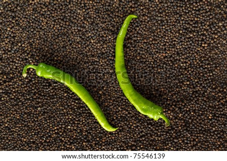 closeup green peppers on black peppercorns