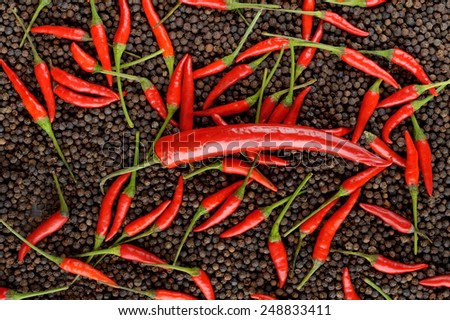 closeup red peppers on black peppercorns