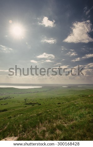 Photo of beautiful landscape with grassy and land lake under sunny skies