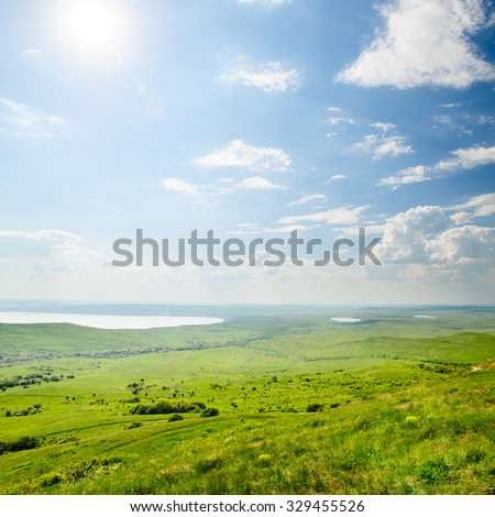 Photo of beautiful landscape with grassy and land lake under sunny skies