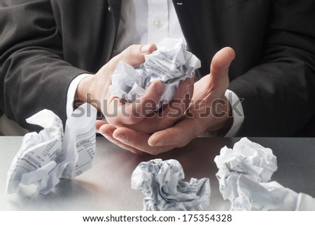 scrap paper balls in hands