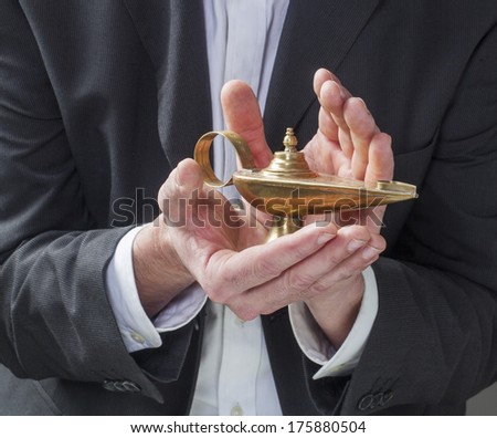 corporate man hands wishing for success with genie lamp