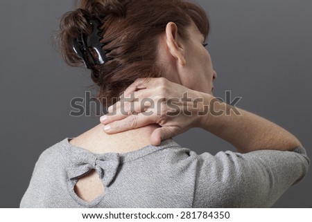 50s woman from the back with fatigue and tension in body