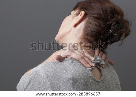 mature woman relaxing pain and pressure in neck and shoulders
