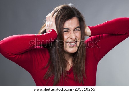 sick young woman having painful headache, covering closed ears, annoyed by loud noise, ignoring someone, not wanting to hear their side of story