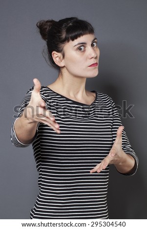 outraged young brunette woman staring at someone with hands forward accusing and patronizing someone