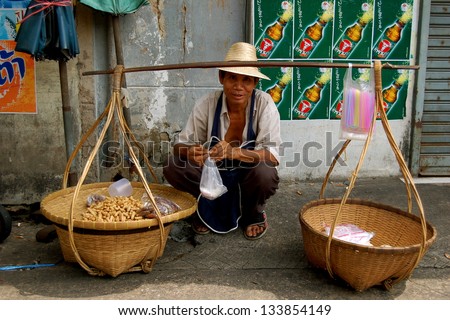 BANGKOK-CIRCA NOVEMBER 2008: An unidentified Thai street seller, Sells snacks to passers by circa November 2008, on the streets in Bangkok.