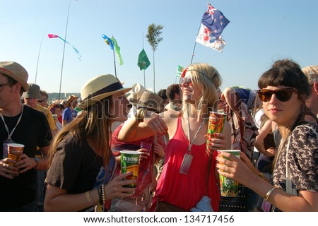 GLASTONBURY,UK - JUNE, 26: A group of festival goers enjoy a cold drink amongst a crowd at Glastonbury Festival on June 26th, 2010 at Pilton Farm in Somerset.