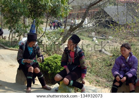 SAPA-CIRCA MARCH 2009: Unidentified Hill-Tribe Women take a break during a tourist trek circa March, 2009 in the hills of Sapa, Vietnam.