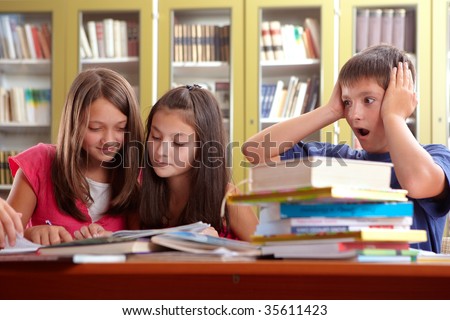 stock photo Two cute schoolgirls learning in a school library