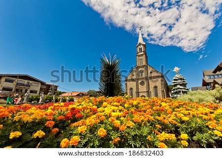 Colorful flowers with St. Peter's church in background. Gramado city, Rio Grande do Sul - Brazil