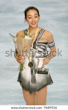 Japan\'s Mao Asada poses at the medal ceremony after winning gold in the ladies figure skating event at the Eric Bompard Trophy Grand Prix.