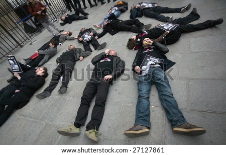 PARIS - MARCH 22: Members of the Act Up organisation lay down by Notre-Dame Cathedral to protest against Pope Benedict XVI\'s remarks on condoms and abortion on March 22, 2009 in Paris, France
