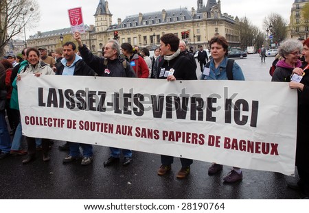 PARIS - APRIL 8: EMMAUS activists protest the law, which prohibits to provide aid to illegal immigrants on April 8, 2009 at Place St. Michel in Paris, France. The banner says \'Let them live here\'