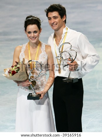 PARIS - OCTOBER 17: Tessa Virtue and Scott Moir (CAN) during the medal ceremony winning gold at Eric Bompard Trophy at Palais-Omnisports de Bercy October 16, 2009 in Paris.