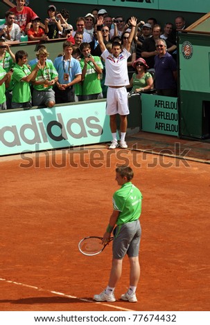 PARIS - MAY 21: Novak Djokovic of Serbia exchanges places with a ball boy during the exhibition match  at French Open, Roland Garros on May 21, 2011 in Paris, France.