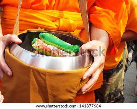 Tradition offer food to monk .