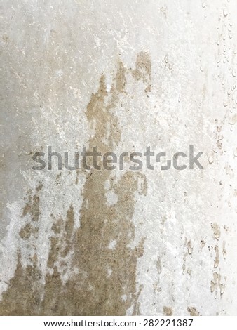 Wet and moist on the grunge cement wall texture background