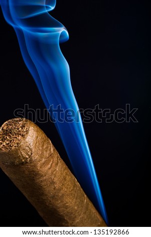 cigar, wisps of smoke on a black background