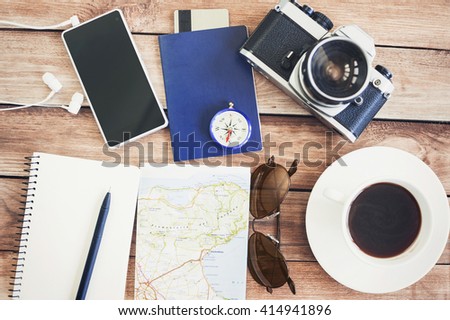 Accessories for travel. Passport, photo camera, smart phone and travel map. Top view. Holidays and tourism concept