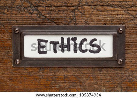 ethics tag - file cabinet label, bronze holder against grunge and scratched wood