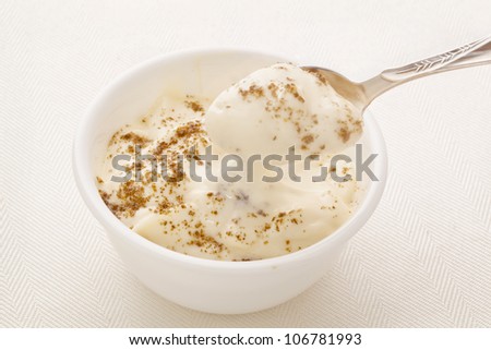 ground chia seeds sprinkled on Greek style yogurt  -  breakfast concept