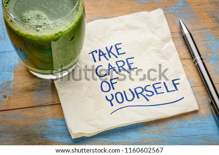 take care of yourself - inspirational handwriting on a napkin with a glass of green juice